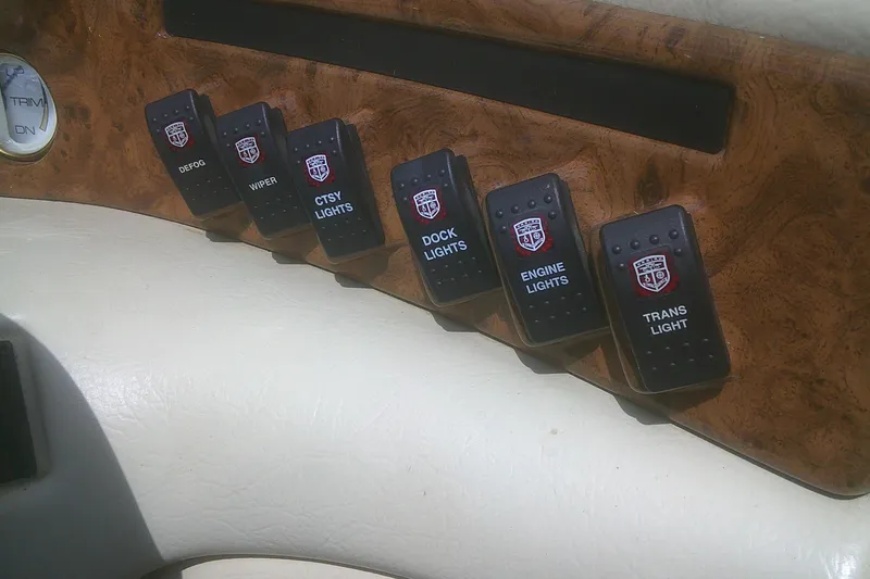 Slide: The Image of Dashboard switches of a 1997 Mariah Z 210 Shabah boat, featuring various light controls. - 11