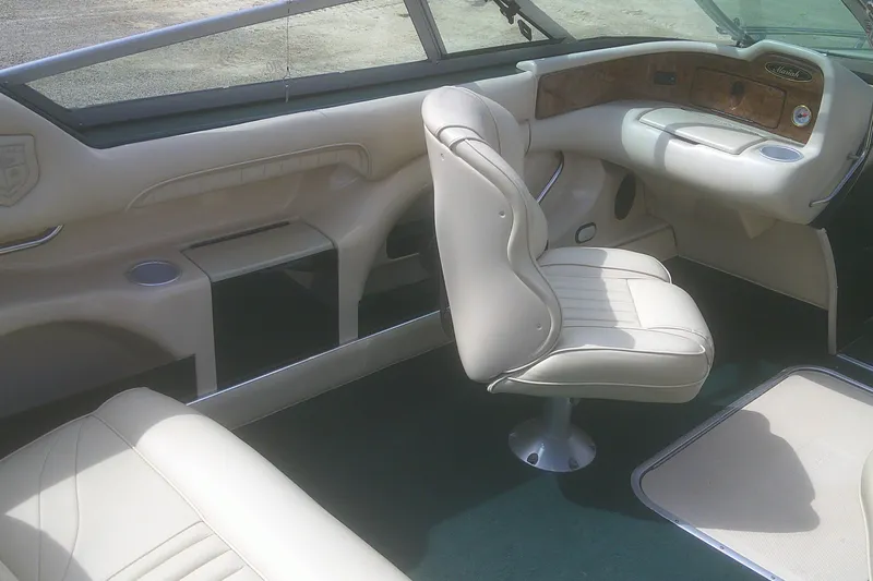 Slide: The Image of Interior of a 1997 Mariah Z 210 Shabah boat with beige seating and dashboard. - 14