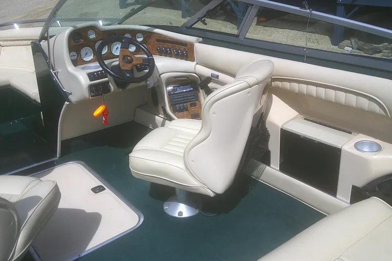 Slide: The Image of 1997 Mariah Z 210 Shabah boat interior with beige leather seats and wood-accented dashboard. - 15
