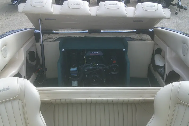 Slide: The Image of 1997 Mariah Z 210 Shabah boat interior with open engine compartment, beige seating. - 16