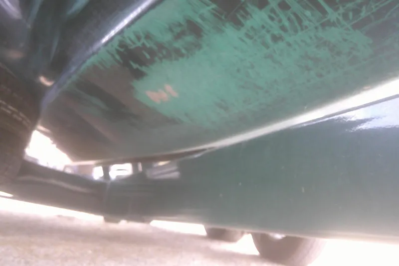 Slide: The Image of Underside view of a 1997 Mariah Z 210 Shabah boat with visible wear. - 22