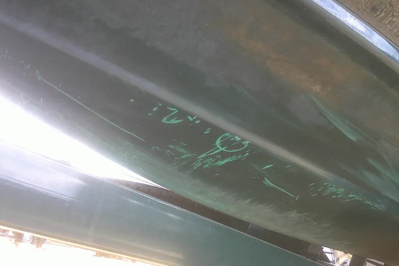 Slide: The Image of Underside view of a 1997 Mariah Z 210 Shabah boat with visible scratches. - 23