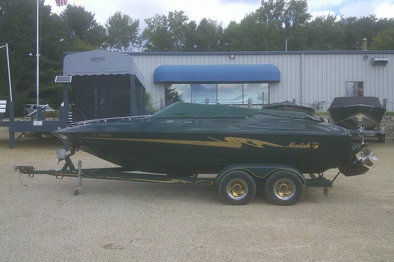 Slide: The Image of 1997 Mariah Z 210 Shabah boat on trailer, parked outside dealership. - 24