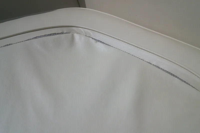 Slide: The Image of Worn upholstery on 1997 Mariah Z 210 Shabah boat seat, showing visible seam damage. - 6