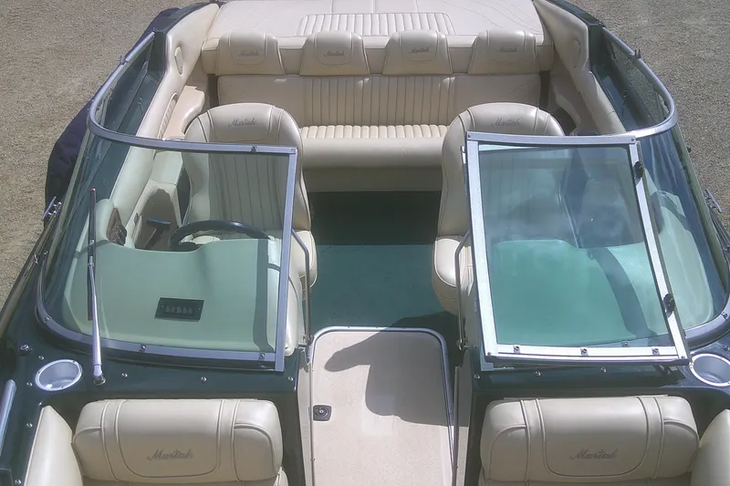 Slide: The Image of 1997 Mariah Z 210 Shabah boat interior with beige leather seats and green carpet. - 7
