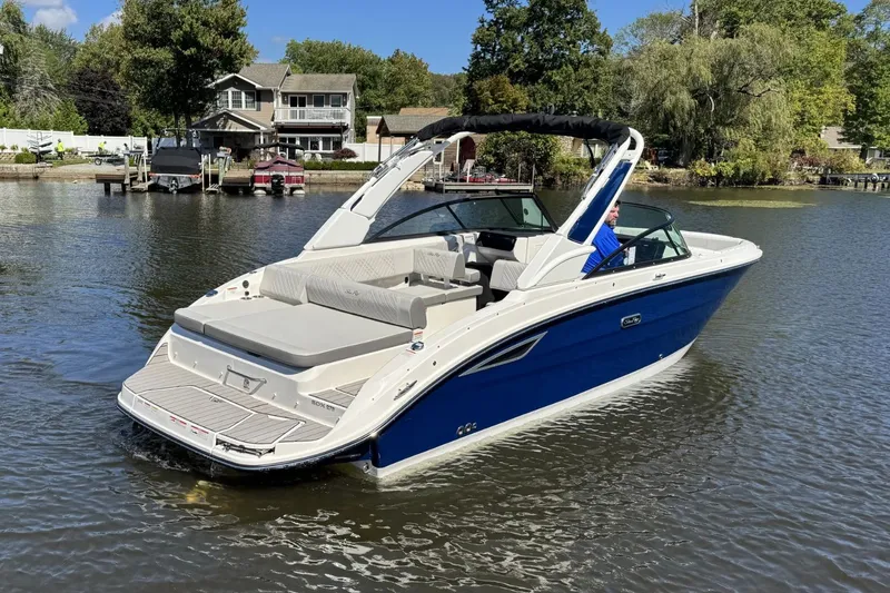 Slide: The Image of 2026 Sea Ray SDX 270 boat on calm water. - 2