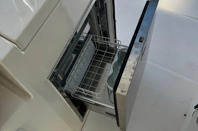 Slide: The Image of Open storage compartment on 2016 Pursuit DC 325 Dual Console boat. - 13