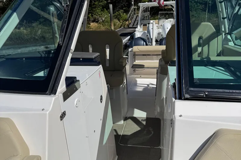 Slide: The Image of 2016 Pursuit DC 325 Dual Console boat interior with seating and console view. - 16