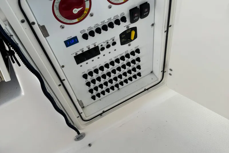 Slide: The Image of Electrical panel of a 2016 Pursuit DC 325 Dual Console boat, featuring switches and controls. - 17