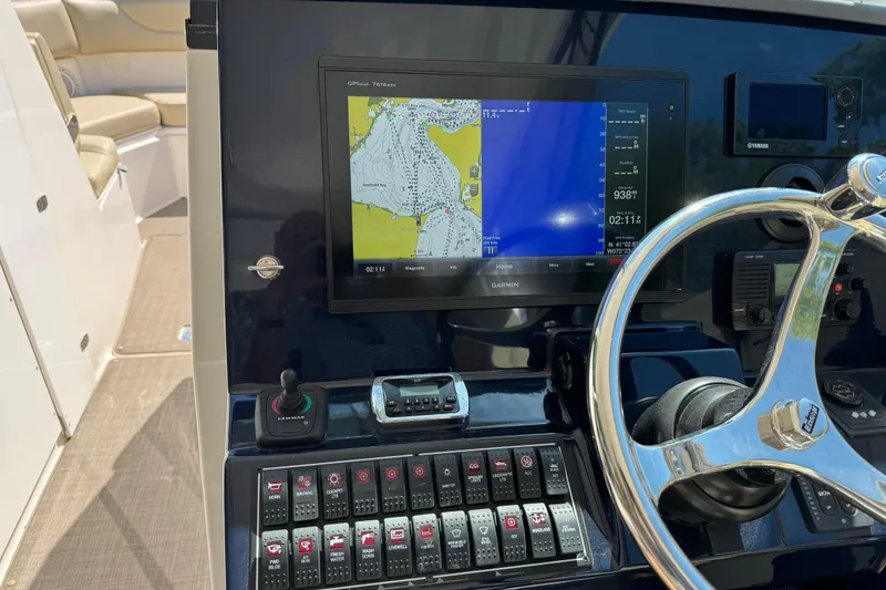 Slide: The Image of 2016 Pursuit DC 325 Dual Console dashboard with Garmin navigation display and controls. - 23