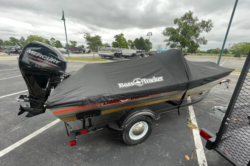 Slide: The Image of 2018 Tracker Bass Tracker 40th Anniversary Heritage Edition boat with cover and Mercury outboard. - 2