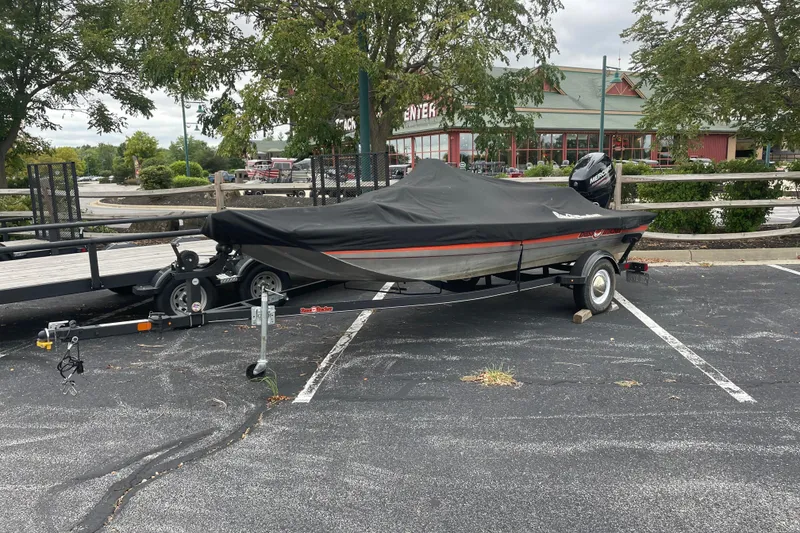 Slide: The Image of 2018 Tracker Bass Tracker 40th Anniversary Heritage Edition boat on trailer, covered, in parking lot. - 3