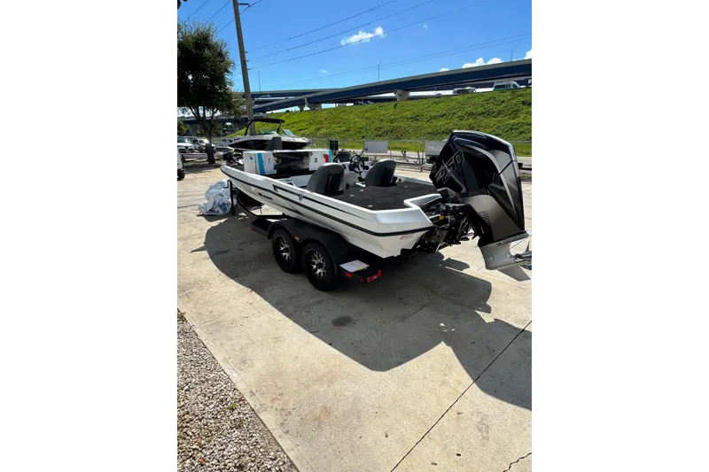 Slide: The Image of 2026 iKon VLE20 boat on trailer, parked outdoors under clear blue sky. - 17