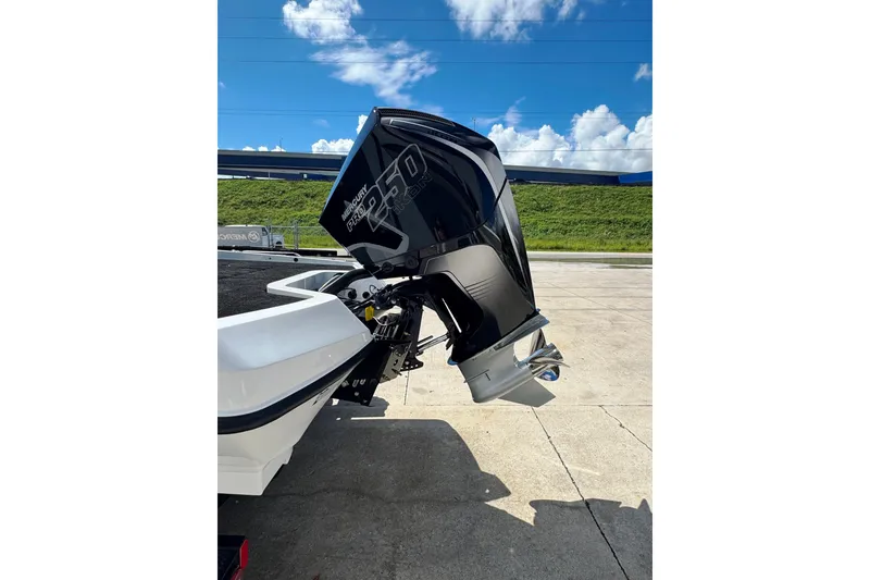 Slide: The Image of 2026 iKon VLE20 boat with Mercury 250 outboard motor, parked on concrete under blue sky. - 19