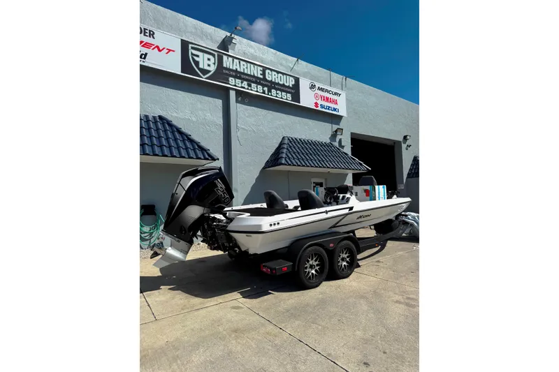 Slide: The Image of Rear view of 2026 iKon VLE20 boat with outboard motor, parked outside a dealership. - 2
