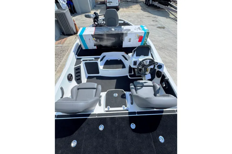 Slide: The Image of 2026 iKon VLE20 boat interior with gray seats and steering console. - 23