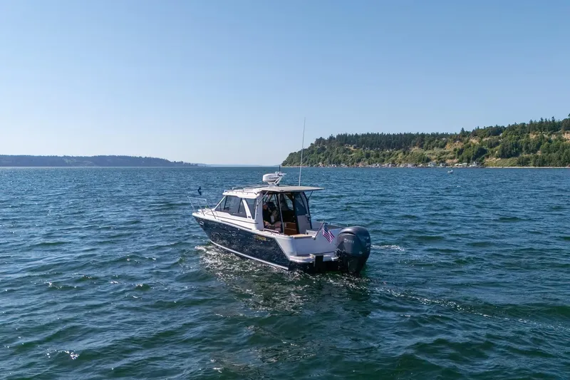 Slide: The Image of 2026 Cutwater C-248 Coupe cruising on a scenic, sunny lake. - 1