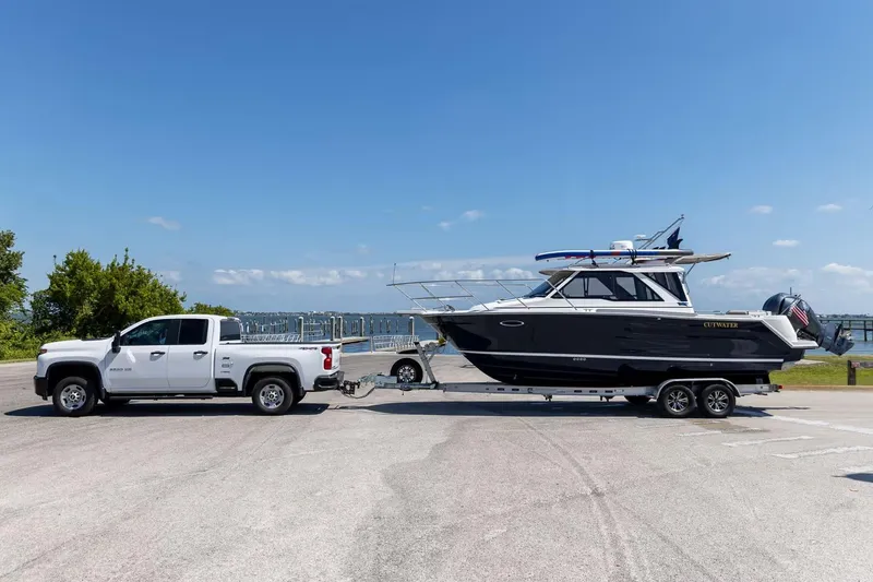 Slide: The Image of 2026 Cutwater C-248 Coupe boat on trailer, towed by white pickup truck. - 3
