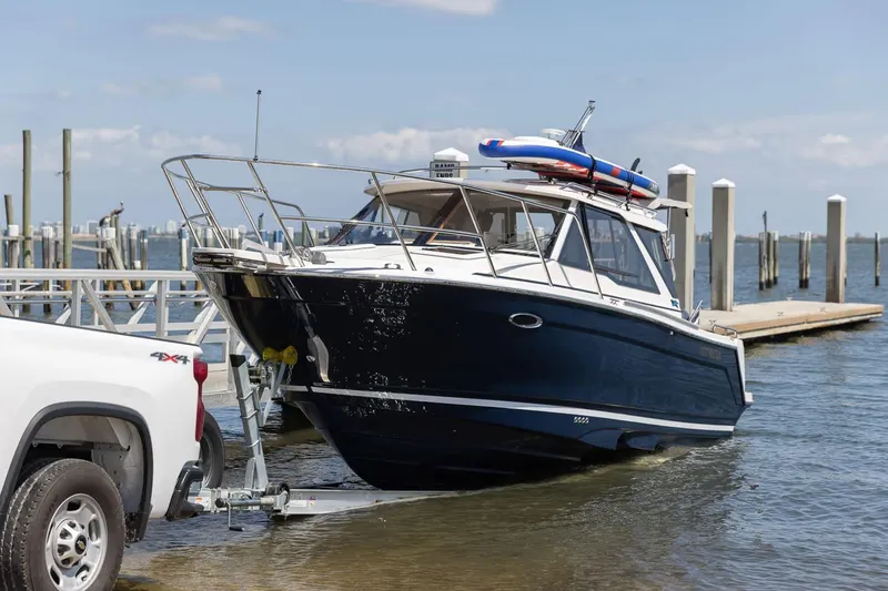 Slide: The Image of 2026 Cutwater C-248 Coupe being launched from a trailer at a marina. - 4