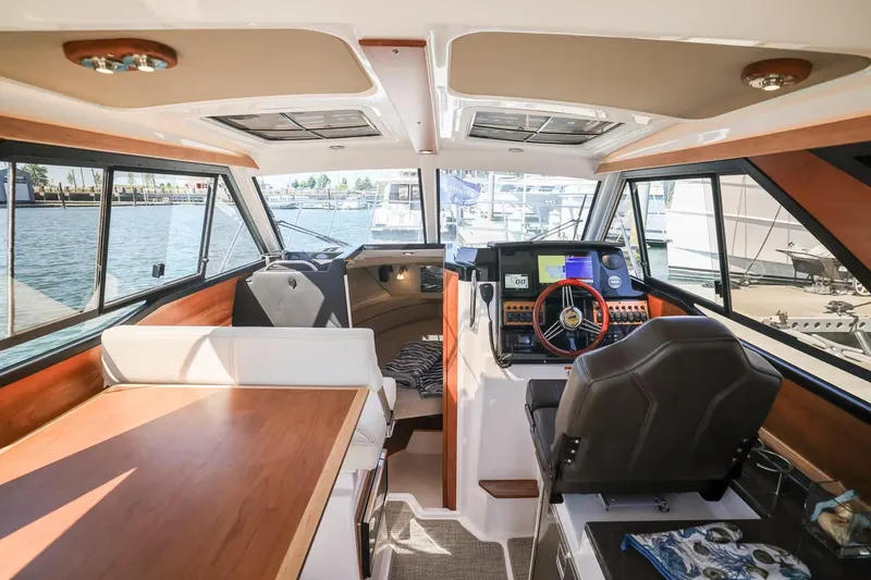 Slide: The Image of Interior of 2026 Cutwater C-248 Coupe boat, featuring helm and seating area. - 8