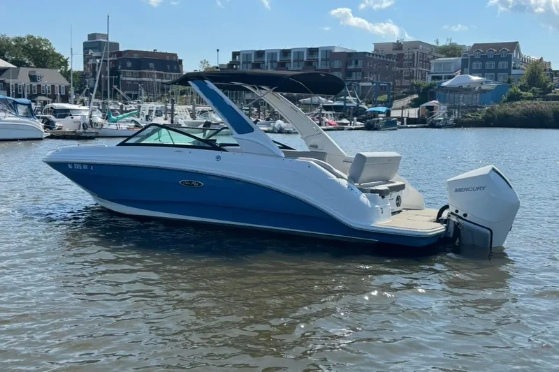 Slide: The Image of 2025 Sea Ray SDX 250 Outboard boat on water, docked in a marina. - 0