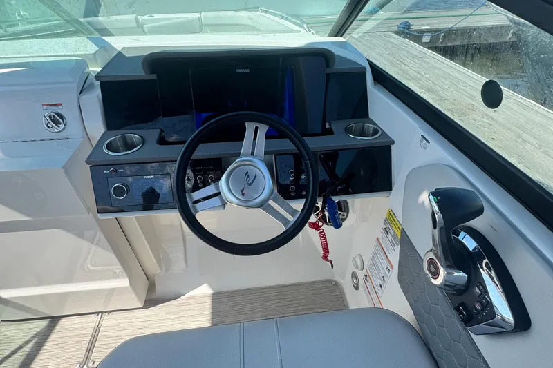 Slide: The Image of 2025 Sea Ray SDX 250 Outboard interior cabin with cushioned seating area. - 12