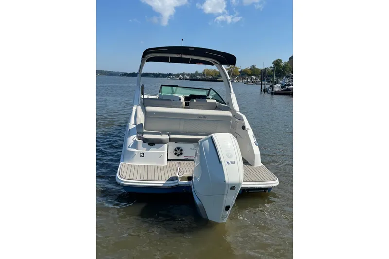 Slide: The Image of 2025 Sea Ray SDX 250 Outboard boat on calm water, featuring a sleek design and powerful engine. - 4