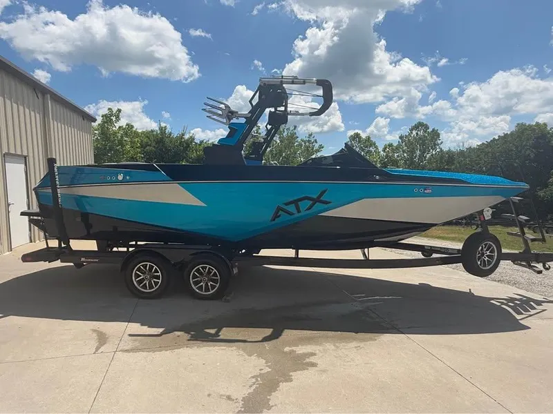 The Image of 2023 ATX Surf Boats 24 Type-S in vibrant blue on trailer, sunny day. - 0