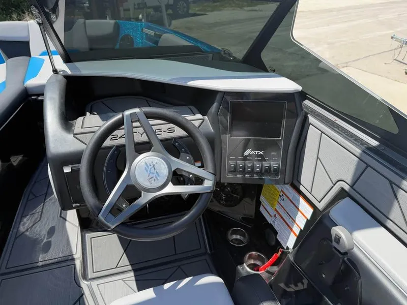 Slide: The Image of 2023 ATX Surf Boats 24 Type-S dashboard with steering wheel and control panel. - 10