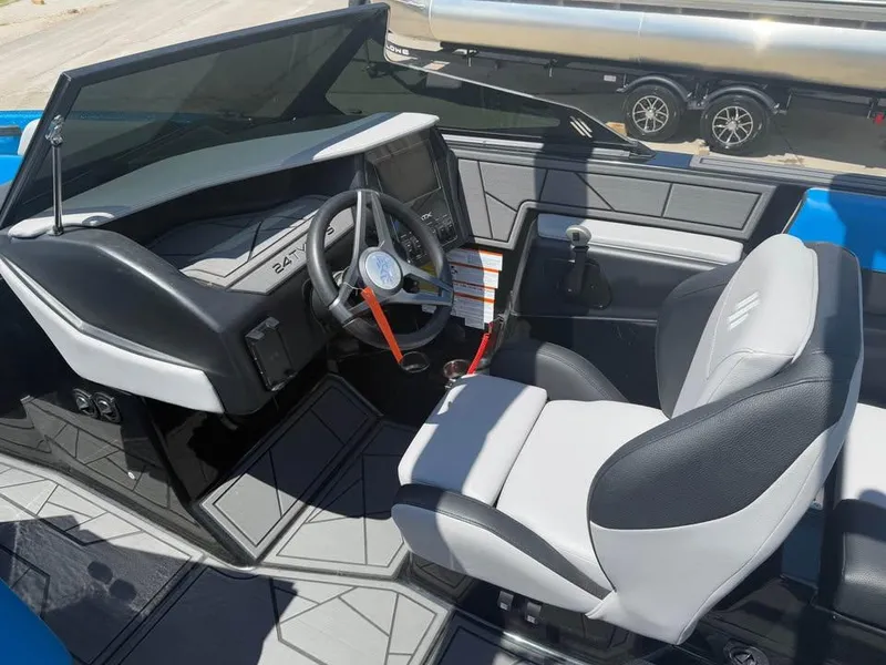 Slide: The Image of 2023 ATX Surf Boats 24 Type-S interior with steering wheel and seating. - 9