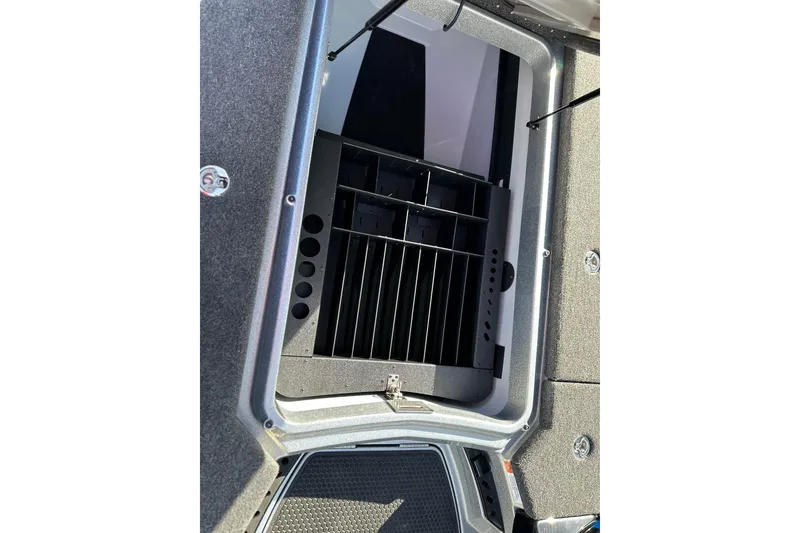 Slide: The Image of Open storage compartment in 2026 iKon LXE21 boat, featuring organized interior sections. - 13