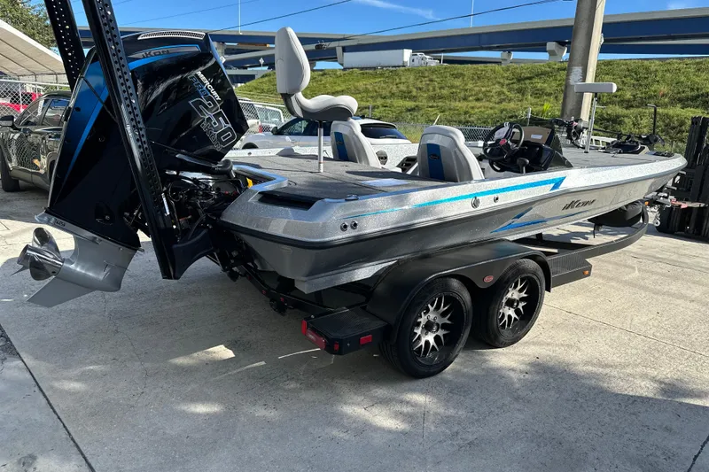 Slide: The Image of 2026 iKon LXE21 boat on trailer, featuring sleek design and powerful engine. - 4