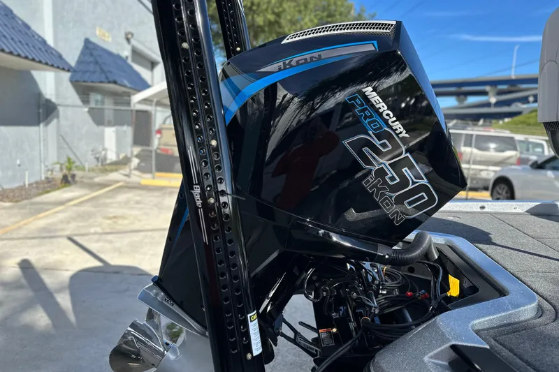 Slide: The Image of 2026 iKon LXE21 Mercury Pro 250 outboard motor in a sunny outdoor setting. - 5