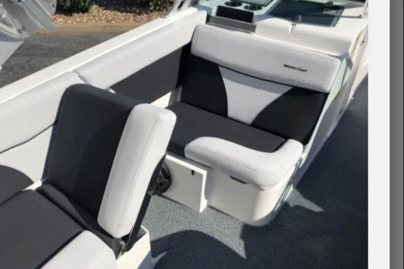 Slide: The Image of 2019 MasterCraft XT25 boat interior with black and white seating. - 13