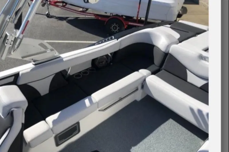 Slide: The Image of 2019 MasterCraft XT25 boat interior with sleek seating and modern design. - 14