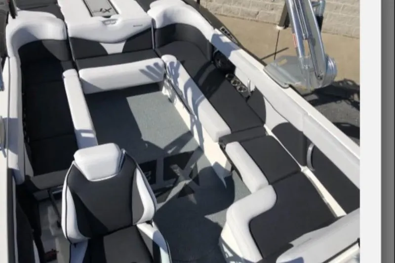 Slide: The Image of 2019 MasterCraft XT25 boat interior with sleek black and white seating design. - 18