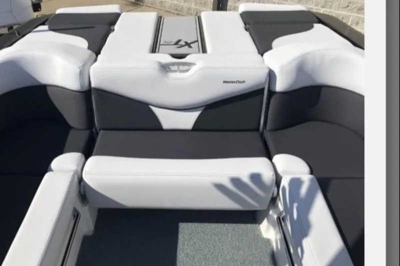 Slide: The Image of 2019 MasterCraft XT25 boat interior with white and black seating. - 19