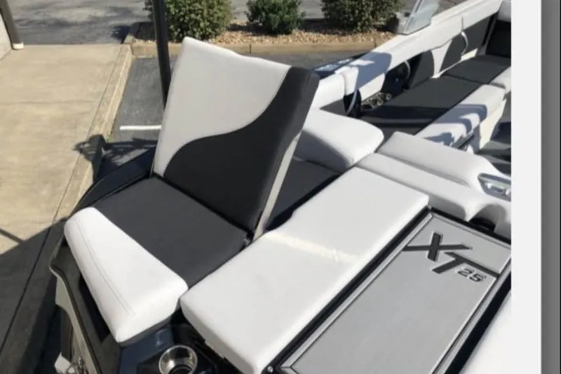 Slide: The Image of 2019 MasterCraft XT25 boat interior with sleek seating and modern design. - 9