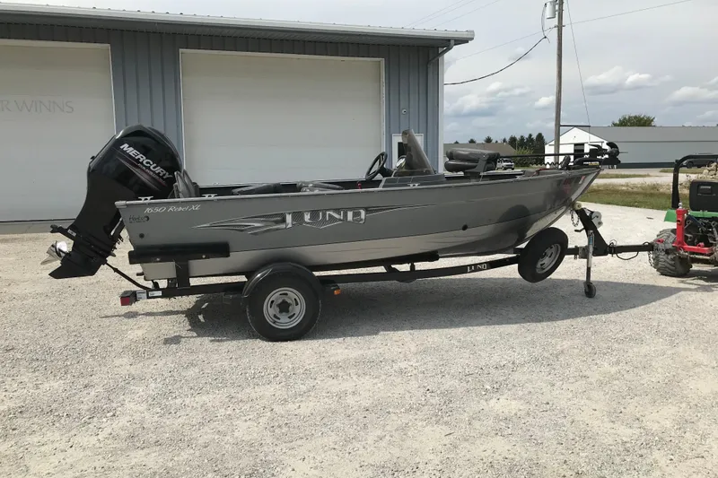 The Image of 2014 Lund 1650 Rebel XL SS boat on trailer with Mercury outboard motor. - 0