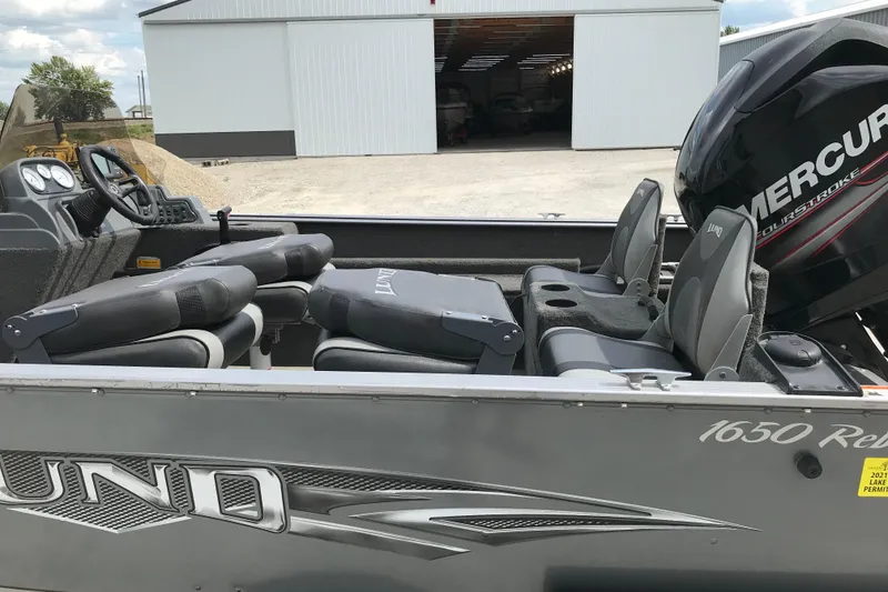 Slide: The Image of 2014 Lund 1650 Rebel XL SS boat with Mercury engine, featuring comfortable seating and modern dashboard. - 10