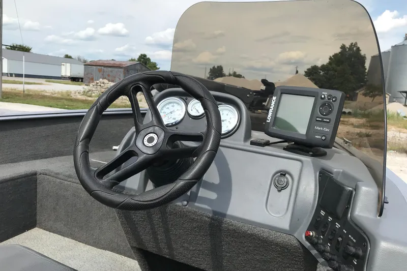 Slide: The Image of 2014 Lund 1650 Rebel XL SS boat dashboard with steering wheel and Lowrance fish finder. - 13