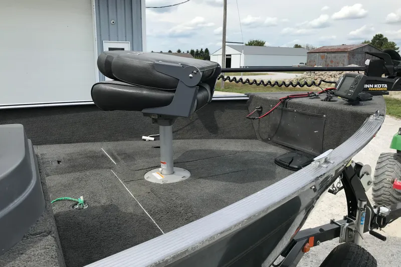 Slide: The Image of 2014 Lund 1650 Rebel XL SS boat interior with seat and fishing equipment. - 15