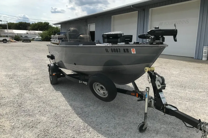 Slide: The Image of 2014 Lund 1650 Rebel XL SS boat on trailer in outdoor setting. - 3