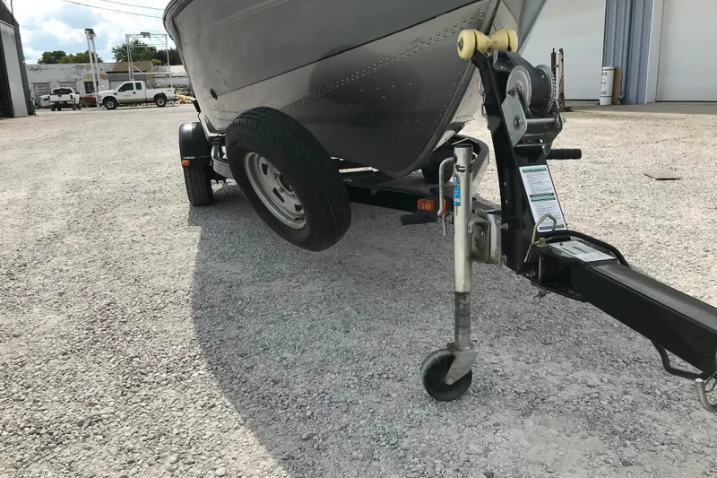 Slide: The Image of 2014 Lund 1650 Rebel XL SS boat on trailer in gravel lot. - 4