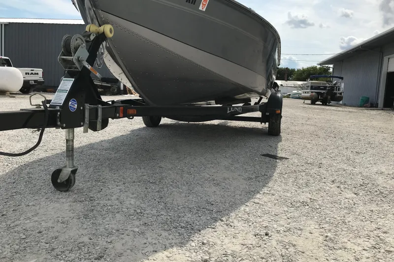 Slide: The Image of 2014 Lund 1650 Rebel XL SS boat on trailer in gravel lot. - 6
