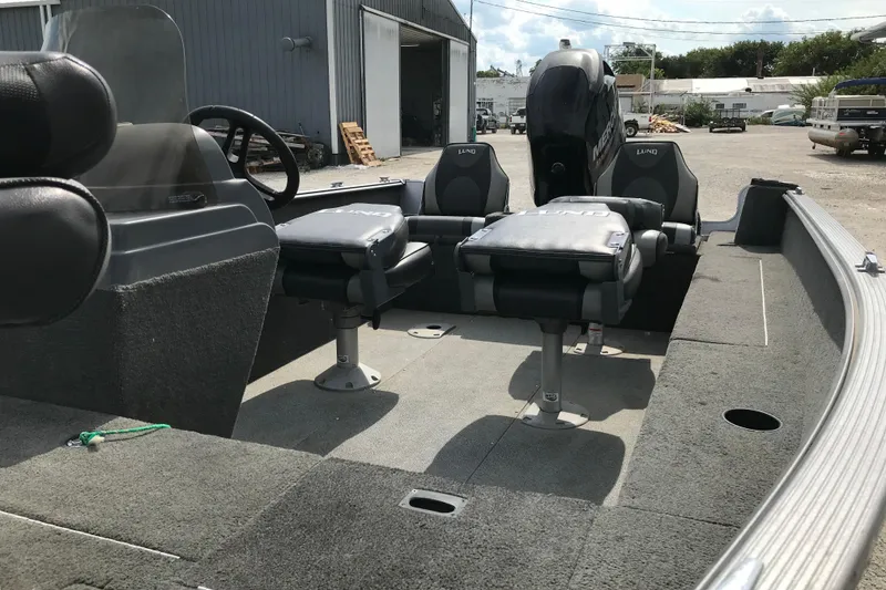 Slide: The Image of 2014 Lund 1650 Rebel XL SS boat interior with seating and steering wheel. - 7