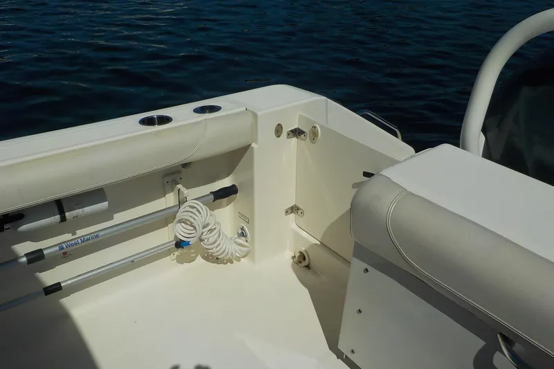 Slide: The Image of 2013 Pursuit DC 265 Dual Console boat interior with seating and marine equipment. - 19