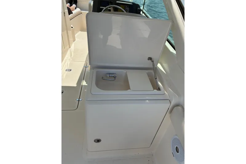 Slide: The Image of 2013 Pursuit DC 265 Dual Console boat sink and storage area. - 22