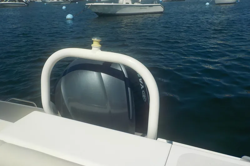 Slide: The Image of 2013 Pursuit DC 265 Dual Console boat with Yamaha outboard motor on water. - 24