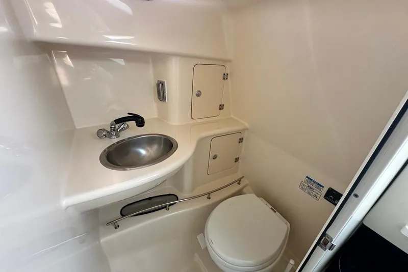 Slide: The Image of 2009 Boston Whaler 285 Conquest boat bathroom with sink and toilet. - 11